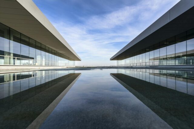 white building reflecting on water